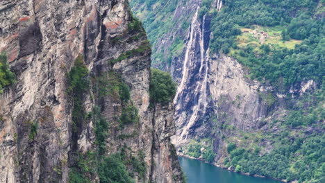 Aerial-View-of-Steep-Cliffs-and-Waterfall-Above-Fjord