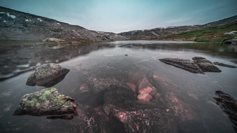 A-timelapse-video-of-a-shallow-pond-with-transparent-water-and-a-rocky-bottom-in-Norwegian-mountains