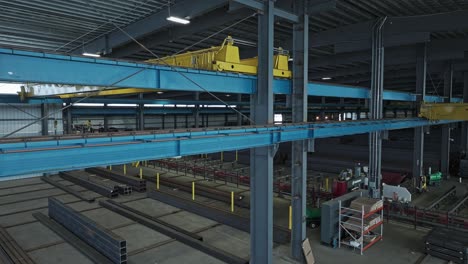Aerial-parallax-around-overhead-bridge-crane-in-steel-beam-warehouse