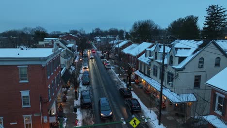 Aerial-establishing-shot-of-snowy-shopping-street-during-winter-season