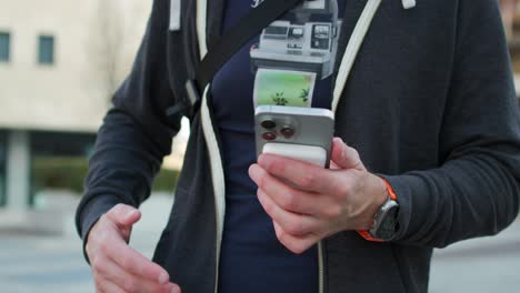 -Person-Placing-Magsafe-Wireless-Charging-Battery-Pack-On-Back-Of-iPhone-Outside