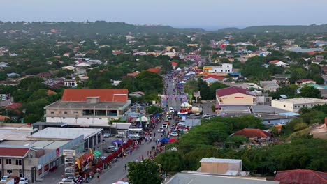 Orbit-of-tropical-Caribbean-paradise-with-Carnaval-parade-watchers-on-side-of-street