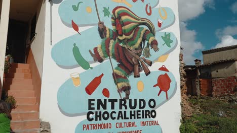 Entrudo-Chocalheiro-Mural-in-Podence-village-center,-Portugal