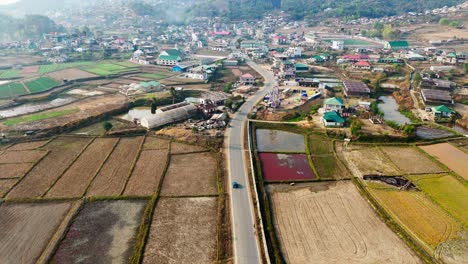 Aerial-shot-a-car-entering-a-countryside-town