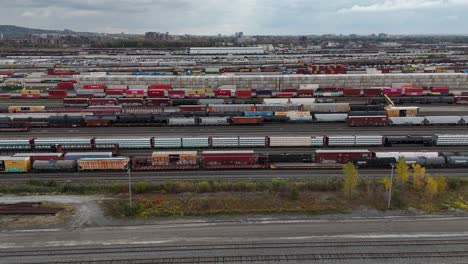 Railyard,-freight-yard-and-freight-trains---aerial-view-tracking-to-the-right