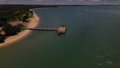 Overhead-aerial-clip-with-slow-tilt-down-of-a-wharf-and-coastline-in-remote-Australia