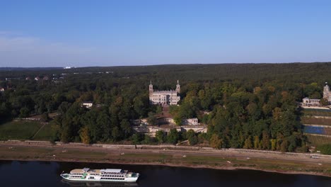 Luxuriöses-Kreuzfahrtschiff-Mit-Majestätischem-Schloss-Am-Ruhigen-Fluss