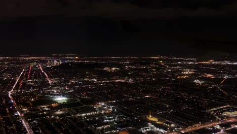 Flying-over-big-Montreal-city-at-night,-Quebec-in-Canada