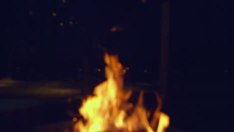 Defocused-bonfire-at-night-creates-cozy-outdoor-background,-copyspace