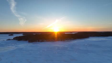 Flying-sideways-over-a-frozen-lake-and-forest-trees-in-the-winter