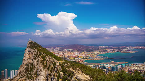 Timelapse-panoramic-view-towards-Rock-of-Gibraltar,-sunny-day-in-coastal-south-of-Spain