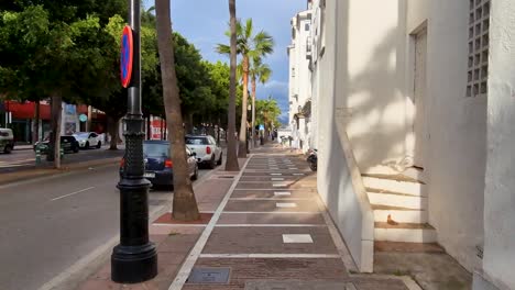 Walking-POV-on-a-Sidewalk-in-Puerto-Banus,-Marbella,-Spain