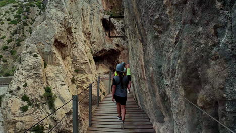 Hiker-ascending-steep-canyon-stairs-at-El-Cabrito,-slow-motion-capture