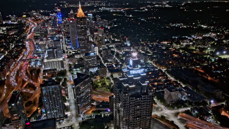 Atlanta-Georgia-Aerial-v895-hyperlapse-drone-fly-around-Truist-plaza-capturing-freeway-traffics,-downtown-night-cityscape-across-O4W,-Sono,-Midtown-and-Tech---Shot-with-Mavic-3-Pro-Cine---July-2023