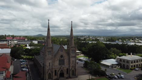 Drone-ascending-showing-a-large-Catholic-Church-and-other-buildings-in-the-background-in-Australia