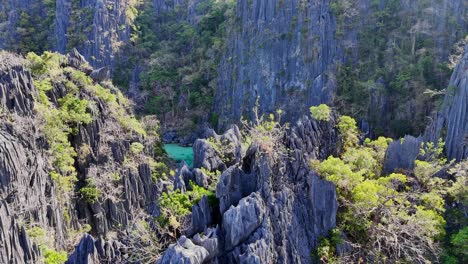 Drone-footage-of-steep-cliffs-revealing-a-lake-on-Coron-island-in-the-Philippines