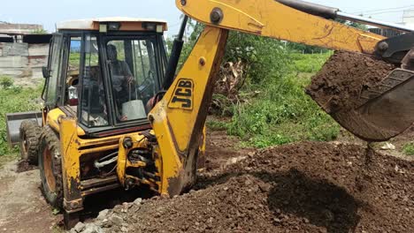excavator-loader-machine-during-earthmoving-works-outdoors-at-the-construction-site