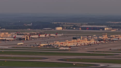 Atlanta-Georgia-Aerial-v966-drone-capturing-South-Cargo-Hangar-and-Delta-airplane-take-off-on-the-runway-of-ATL-Hartsfield-International-Domestic-Concourses---Shot-with-Mavic-3-Pro-Cine---June-2023