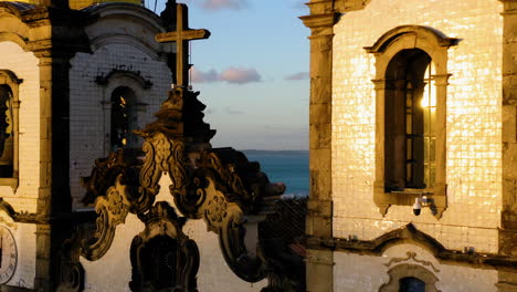 Aerial-view-of-Nosso-Senhor-do-Bonfim-church,-the-city-around-and-the-ocean-at-background,-Salvador,-Bahia,-Brazil