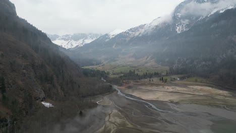 Dried-river-into-the-Klöntalersee-lake-in-Glarus,-Switzerland