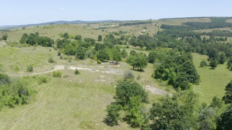 Panoramic-Aerial-View-Of-People-Trekking-Towards-The-Dolmen-Near-The-Village-Of-Hlyabovo-In-Topolovgrad,-Bulgaria