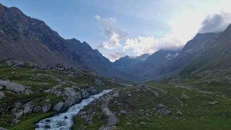 Half-Cloudy-Breath-taking-Time-Lapse-featuring-Rocky-Vegetation-Landscape-and-Blue-Stream