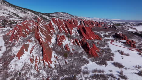 March-winter-morning-snow-stunning-Roxborough-State-Park-Littleton-Colorado-aerial-drone-landscape-sharp-jagged-dramatic-red-rock-formations-Denver-foothills-front-range-blue-sky-forward-motion