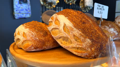 Fresh-sourdough-bread-loafs-at-a-bakery,-golden-loafs,-4K-shot