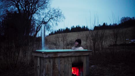 Bearded-Man-Enjoying-And-Relaxing-In-A-Hot-Tub-In-The-Farm-At-Night