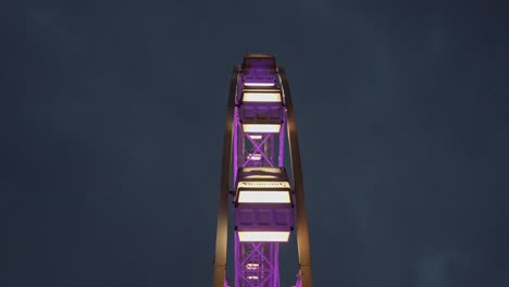 Static-purple-ferris-wheel-shot-in-night-time,-low-angle,-up-shot