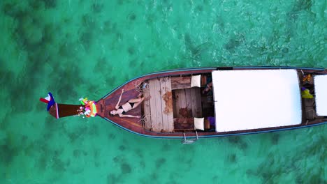 Girl-lies-on-longtail-boat-in-bay-thailand