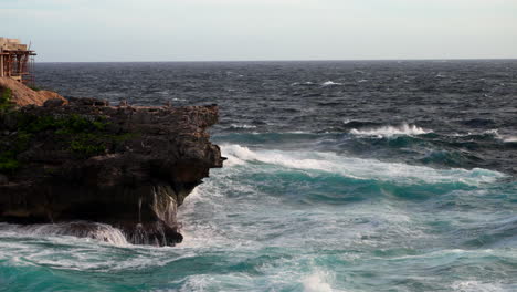 Untamed-ocean-water-crashing-against-shoreline-rock-formations