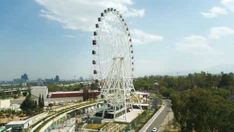 Aerial-view-rising-up-in-rollercoaster-Aztlán-urban-park-in-Chapultepec,-Mexico-City,-chapultepec