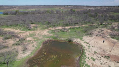 Aerial-flight-over-a-pond-on-a-ranch-in-Texas