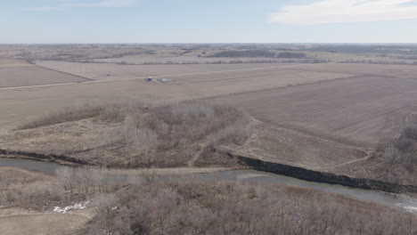 West-Nodaway-River,-meandering-through-agricultural-land,-from-above,-in-winter