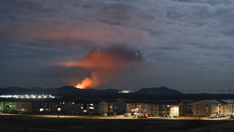 Active-volcano-in-Iceland,-red-sky-lightened-by-lava,-neighborhood-backyard-eruption
