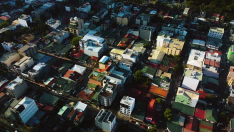 Vivid-houses-in-the-Olympia-Barangay,-in-sunny-Makati,-Philippines---Aerial-view