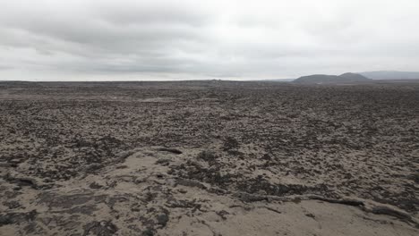 Barren-lava-fields-in-Reykjanes-Peninsula,-Iceland,-low-aerial-view-on-overcast-day