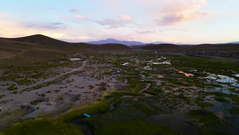Twilight-hues-over-Chilean-wetlands-with-Andes-backdrop,-aerial-view