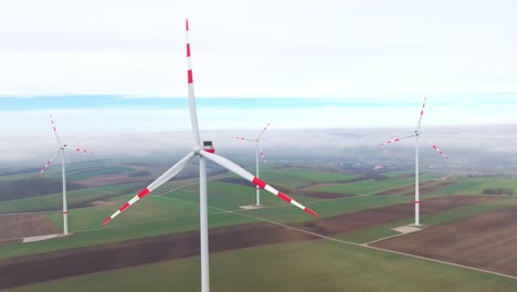 Closeup-Of-Rotating-Wind-Turbines-With-Red-Stripes-on-Blades