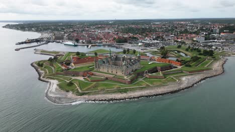 huge-castle-directly-on-the-coast,-kronborg-slot,-little-town,-baltic-sea,-helsingor,-denmark,-europe,-drone