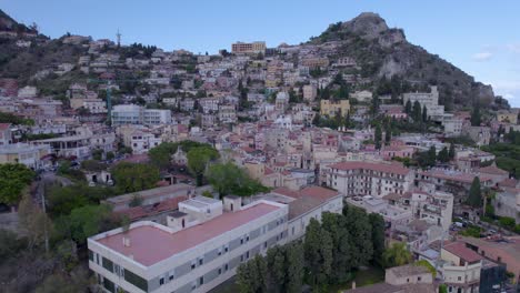 Aerial-descend-shot-of-Taormina,-Sicily,-Italy-a-famous-tourist-destination,-south-side-of-the-city