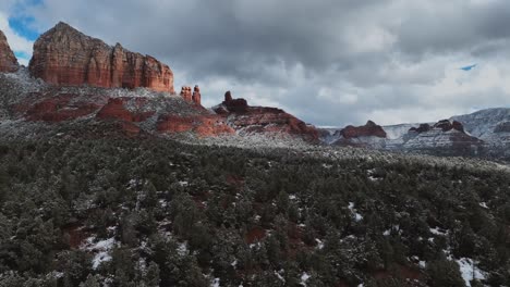 Snow-Covered-Red-Rocks-And-Vegetation-Near-Sedona,-Arizona---Drone-Shot