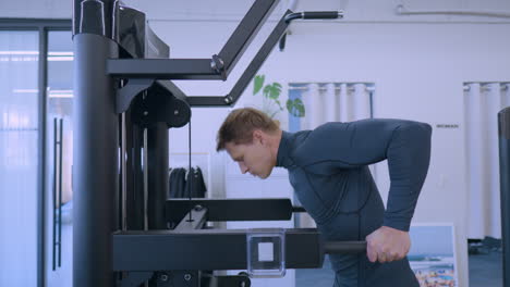 Young-muscular-man-workout-at-gym-doing-dip-exercise-training-chest-and-tricep-muscles---side-view-slow-motion