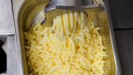 Preparation-of-filling-for-dumplings,-boiled-potatoes-are-ground-in-a-meat-grinder