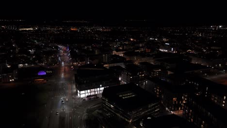 Urban-city-skyline-of-Reykjavik-at-night-in-Iceland,-aerial