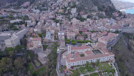 Aerial-orbit-over-Taormina,-Sicily,-Italy-a-famous-tourist-destination,-south-side-of-the-city