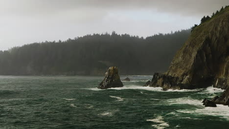Slow-aerial-pan-across-Pacific-Ocean-breaking-against-rocky-Oregon-Coast