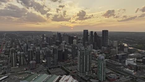 Calgary-AB-Canada-Aerial-v55-drone-flyover-Victoria-park-across-East-Village-capturing-cityscape-of-Beltline,-Downtown-Commercial-and-Eau-Claire-at-sunset---Shot-with-Mavic-3-Pro-Cine---July-2023