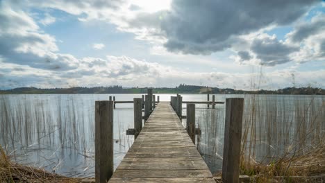 Restless-clouds-move-over-a-lake-on-a-jetty